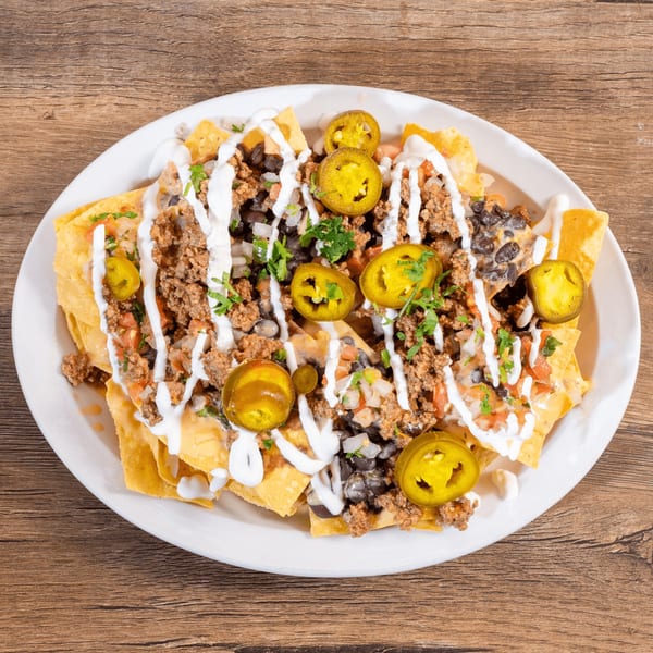 Don Julio's nachos with ground beef, black beans, pico de gallo, sour cream, and jalapeños.