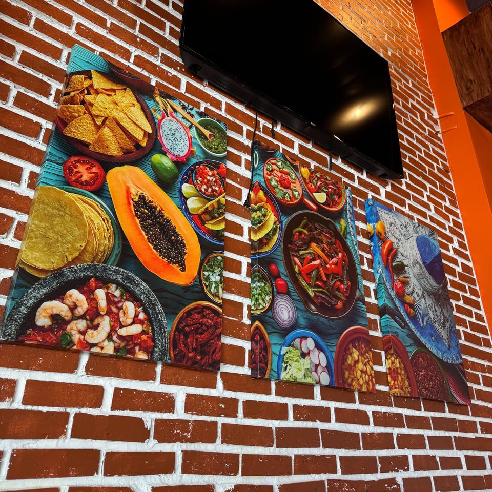 Wall art at Don Julio's featuring vibrant Mexican food, including nachos, papaya, and fajitas.