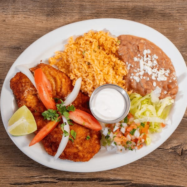 Don Julio's Mexican dish with fried fish, rice, refried beans, pico de gallo, and lime.